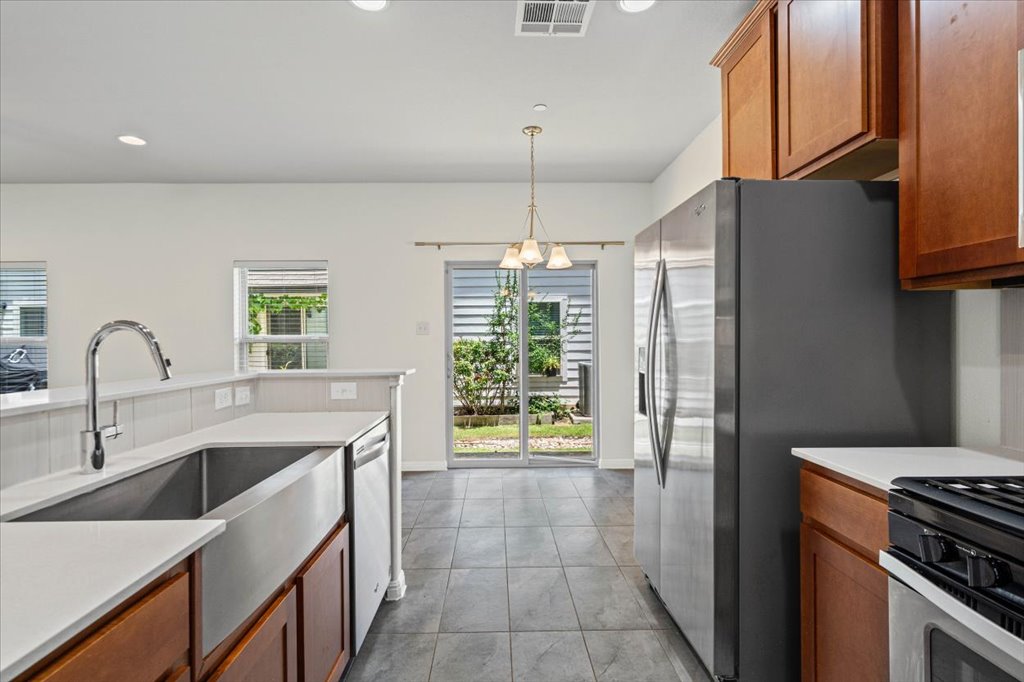 1502 Airedale Road, Unit 2502 Austin, TX 78748 - Photo 3 of 28 A well-equipped kitchen space offers modern appliances and access to the outdoor area.