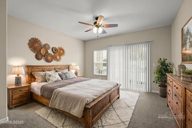 a spacious bedroom with a bed and a chandelier
