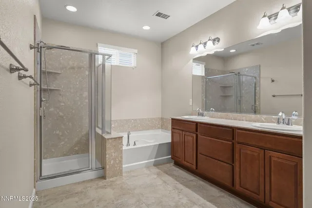 a bathroom with a double vanity sink mirror and shower