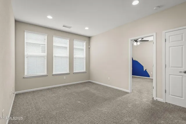 an empty room with windows and closet