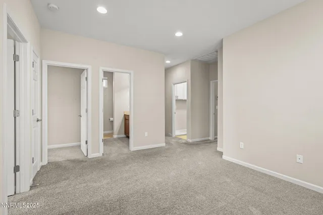an empty room with closet and bathroom