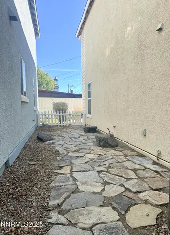 a view of a livingroom with wooden floor and a sink