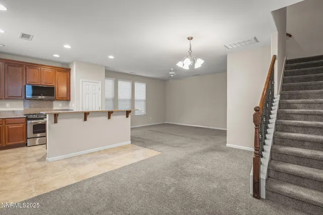 a view of a kitchen with a sink wooden floor and staircase