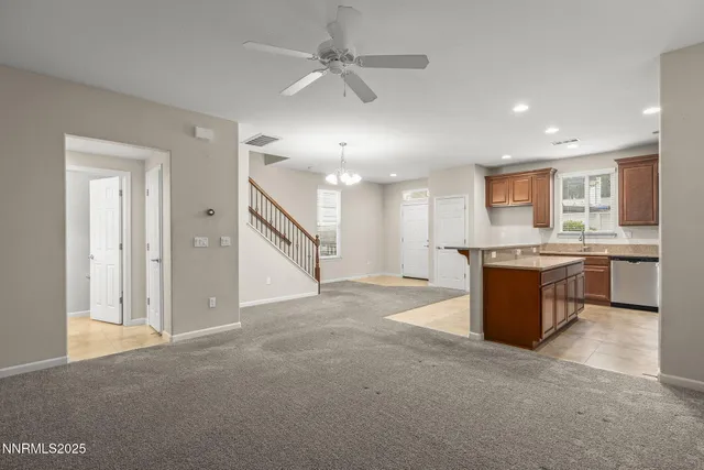 a view of a kitchen with a stove a sink cabinets and a refrigerator