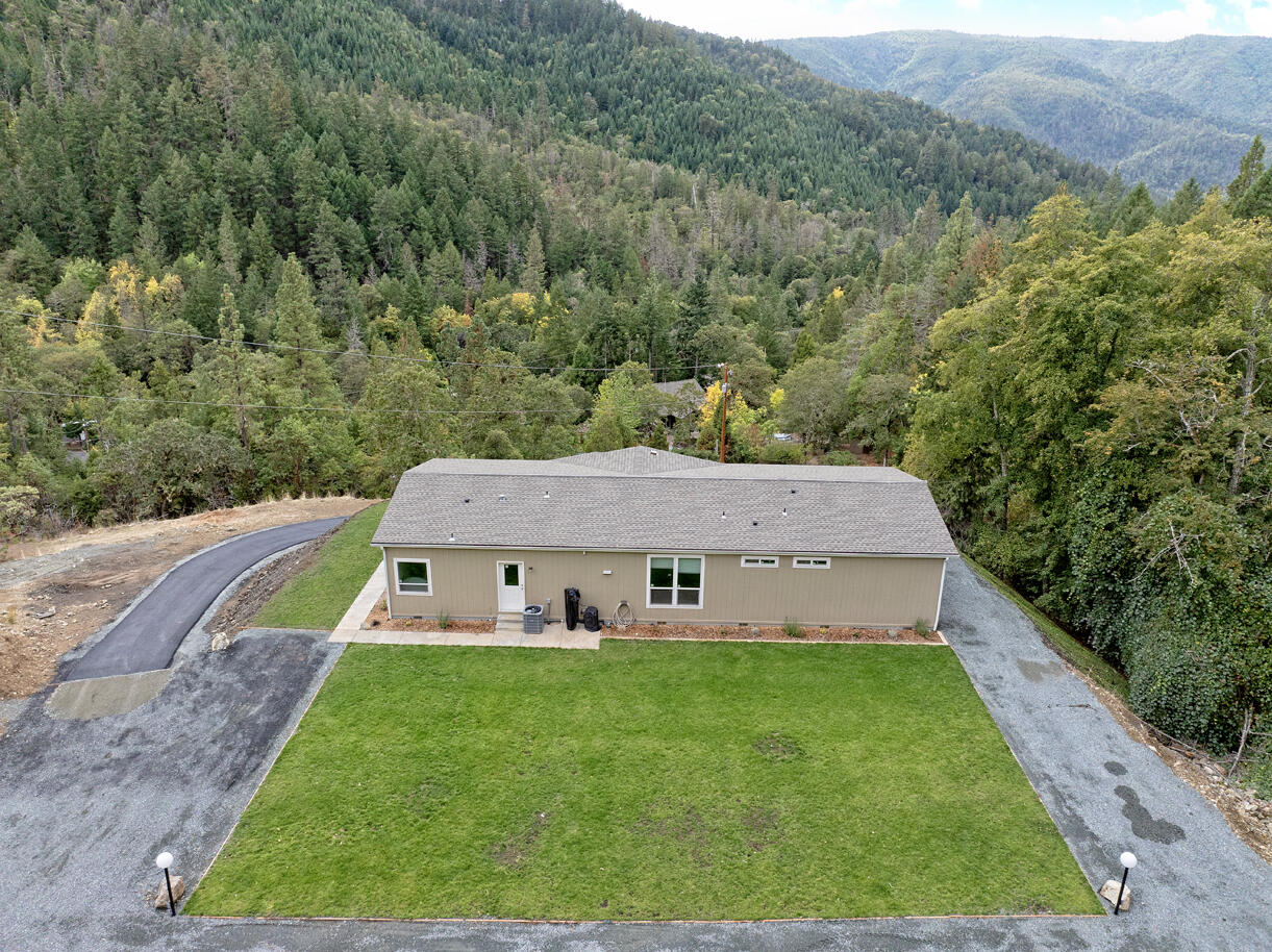 5572 Jumpoff Joe Creek Road Grants Pass, OR 97526 - Photo 31 of 38 a view of an house with a yard