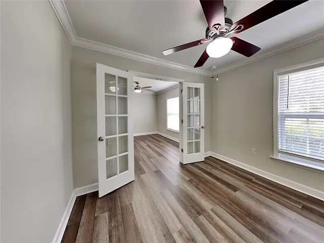 wooden floor in an empty room with a window
