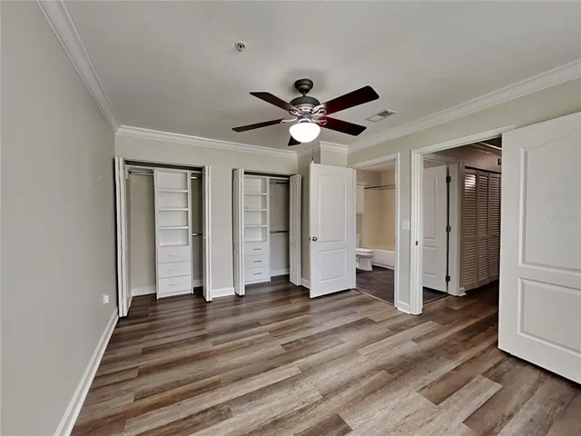 a view of a livingroom with wooden floor and a ceiling fan