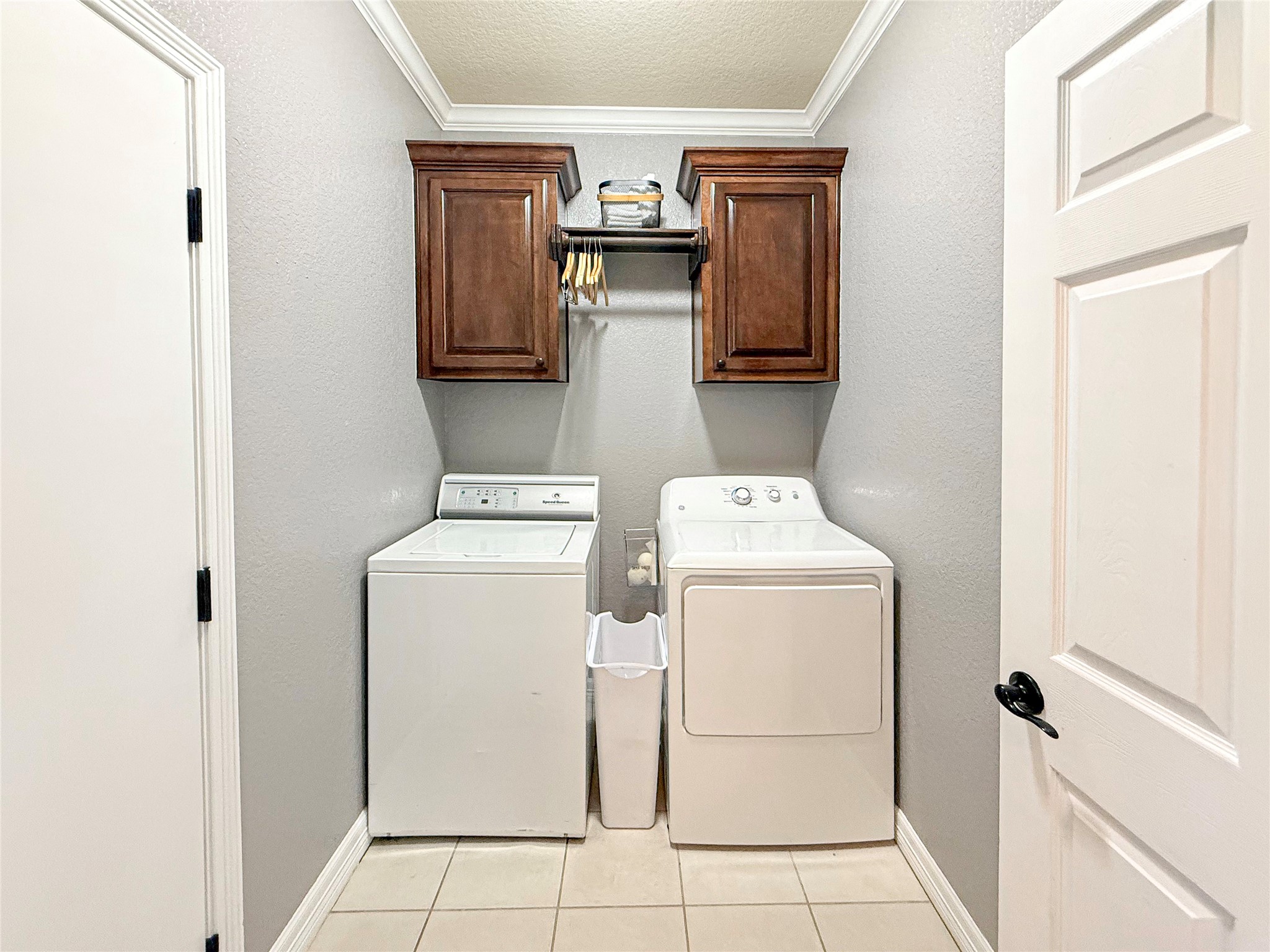 807 Mill Road Angleton, TX 77515 - Photo 30 of 46 Functional indoor utility room with custom cabinetry and convenient hanging rod.