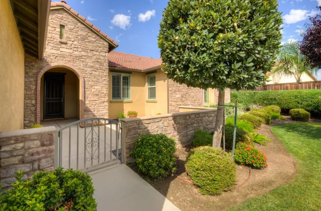a front view of a house with garden