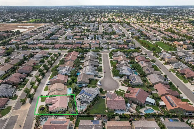 an aerial view of residential houses with outdoor space