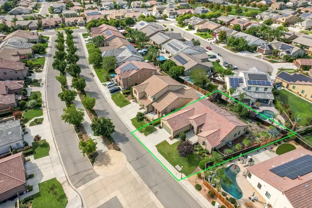 an aerial view of residential houses with green space