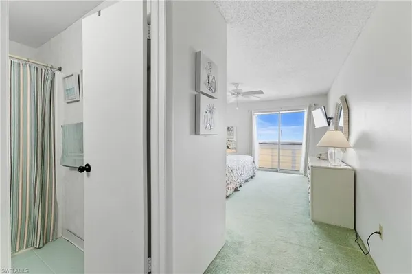 a view of kitchen with refrigerator cabinets and wooden floor