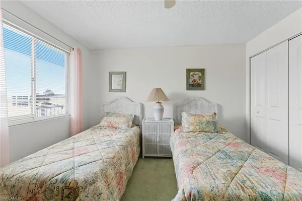 a bedroom with two beds and a window