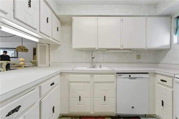 a kitchen with stainless steel appliances granite countertop a sink and cabinets
