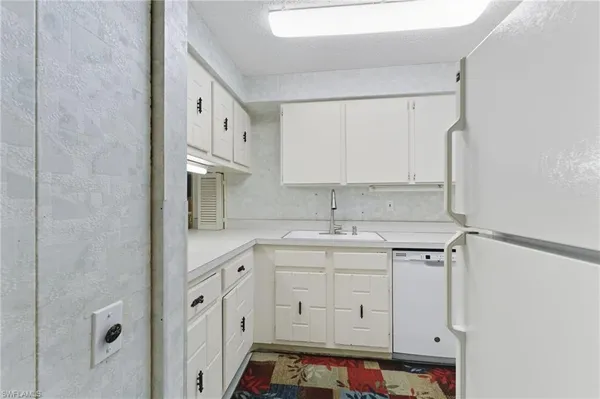 a kitchen with cabinets appliances and a sink