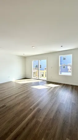 a view of a room with wooden floor and window