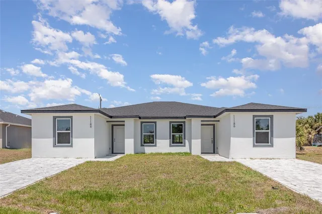 a view of house with outdoor space and garden