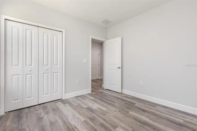 an empty room with wooden floor