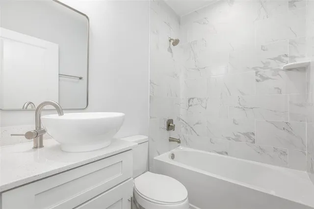 a bathroom with a sink a toilet and a bathtub