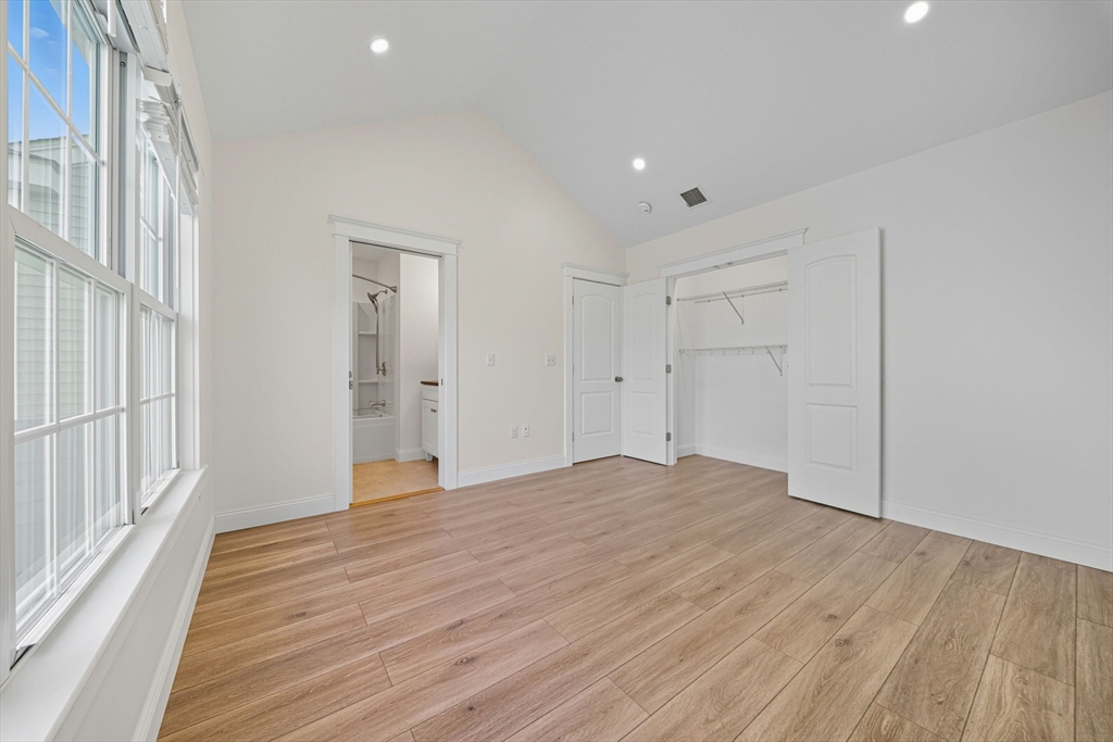3 Spotted Turtle Path, Unit 242 Canton, MA 02021 - Photo 17 of 36 a view of an empty room with wooden floor and a window