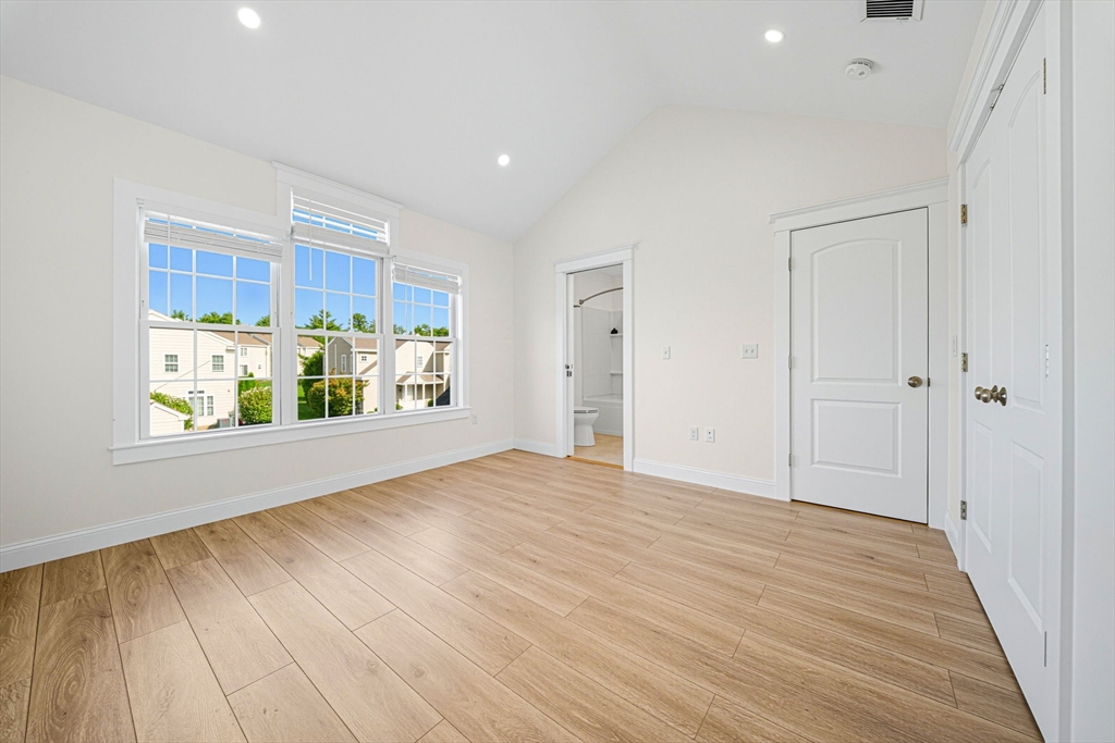 3 Spotted Turtle Path, Unit 242 Canton, MA 02021 - Photo 18 of 36 a view of an empty room with a window and wooden floor