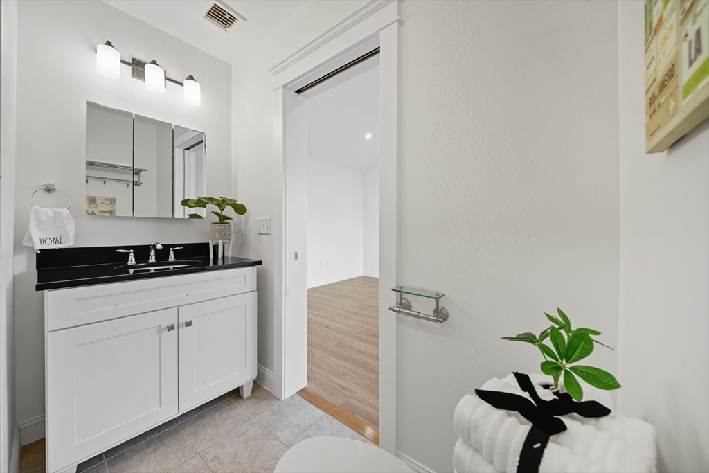3 Spotted Turtle Path, Unit 242 Canton, MA 02021 - Photo 22 of 36 a bathroom with a sink and a mirror