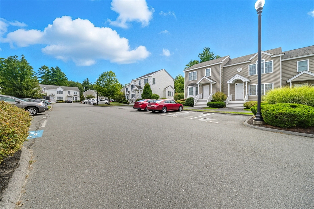 3 Spotted Turtle Path, Unit 242 Canton, MA 02021 - Photo 35 of 36 a front view of a house with a garden and pathway