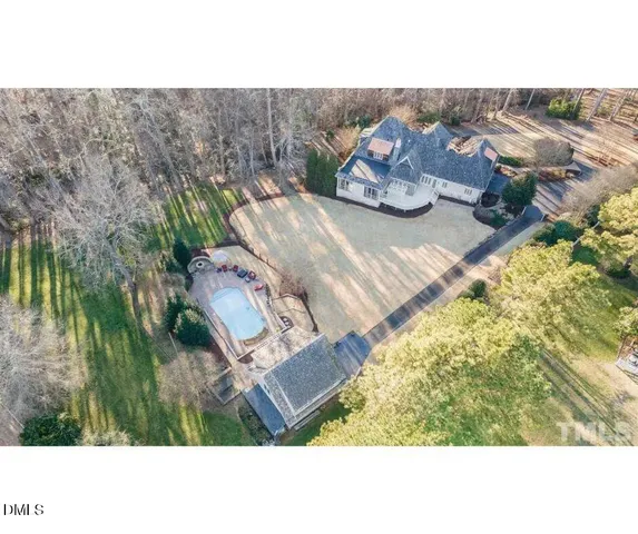 a kitchen with stainless steel appliances granite countertop a refrigerator a stove and white cabinets with wooden floor