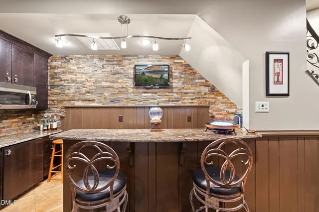 a living room with furniture a rug and a fireplace