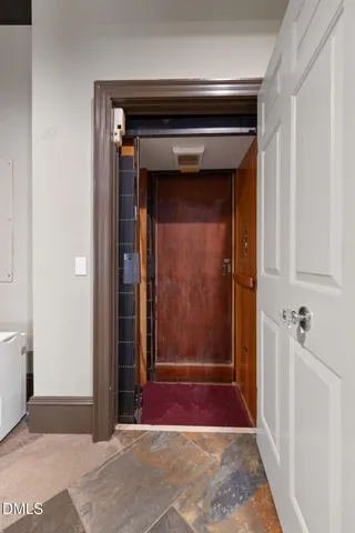 a living room with fireplace furniture and a chandelier