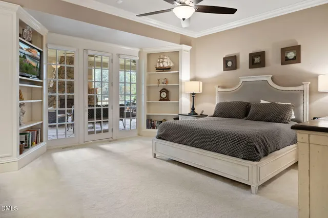 a living room with furniture a large window and wooden floor