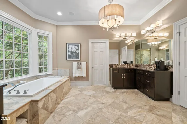 a kitchen with stainless steel appliances granite countertop a stove and white cabinets