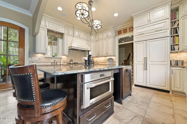 a spacious bedroom with a bed and a chandelier