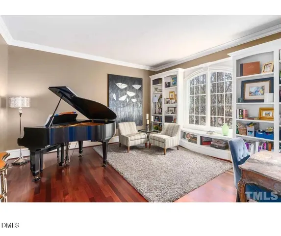 a kitchen with stainless steel appliances kitchen island granite countertop a table chairs and a refrigerator