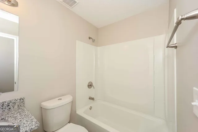 a bathroom with a toilet and a bathtub
