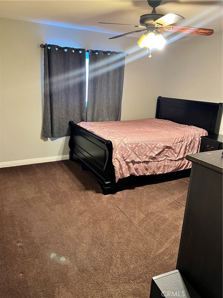 866 North Eucalyptus Avenue Rialto, CA 92376 - Photo 11 of 20 a bedroom with a bed and a ceiling fan