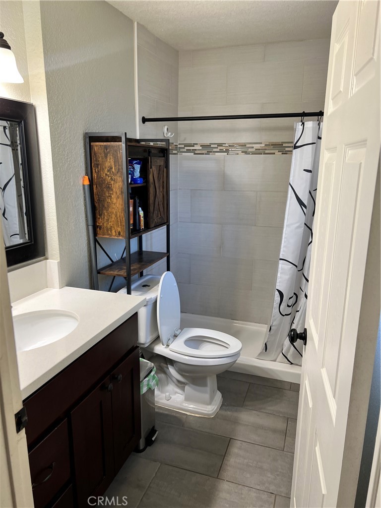 866 North Eucalyptus Avenue Rialto, CA 92376 - Photo 12 of 20 a bathroom with a sink toilet and shower