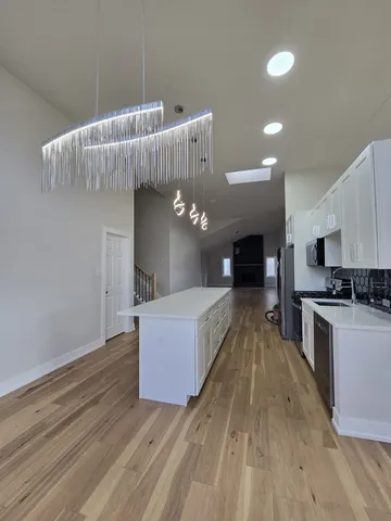 a living room with furniture and a kitchen