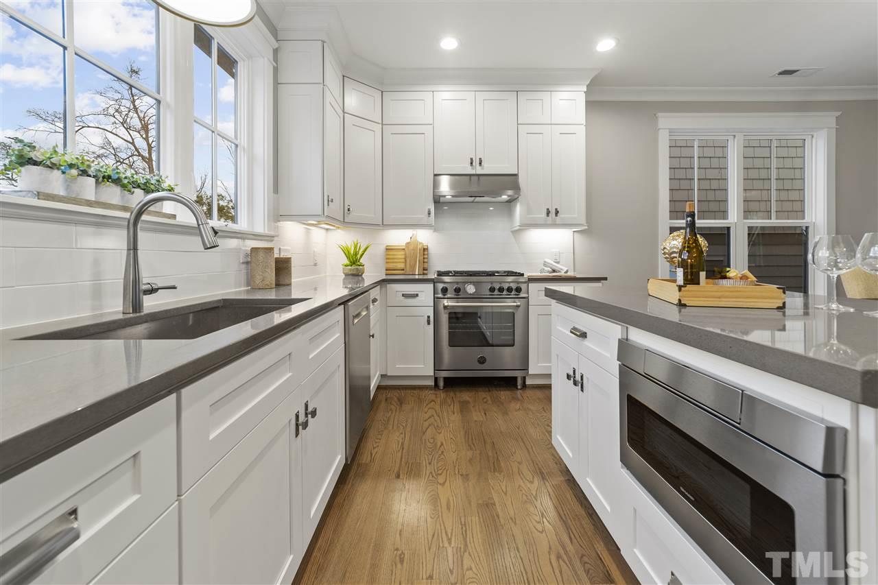 507 Hamilton Cottage Way Raleigh, NC 27605 - Photo 11 of 30 a kitchen with stainless steel appliances granite countertop a sink a stove and cabinets