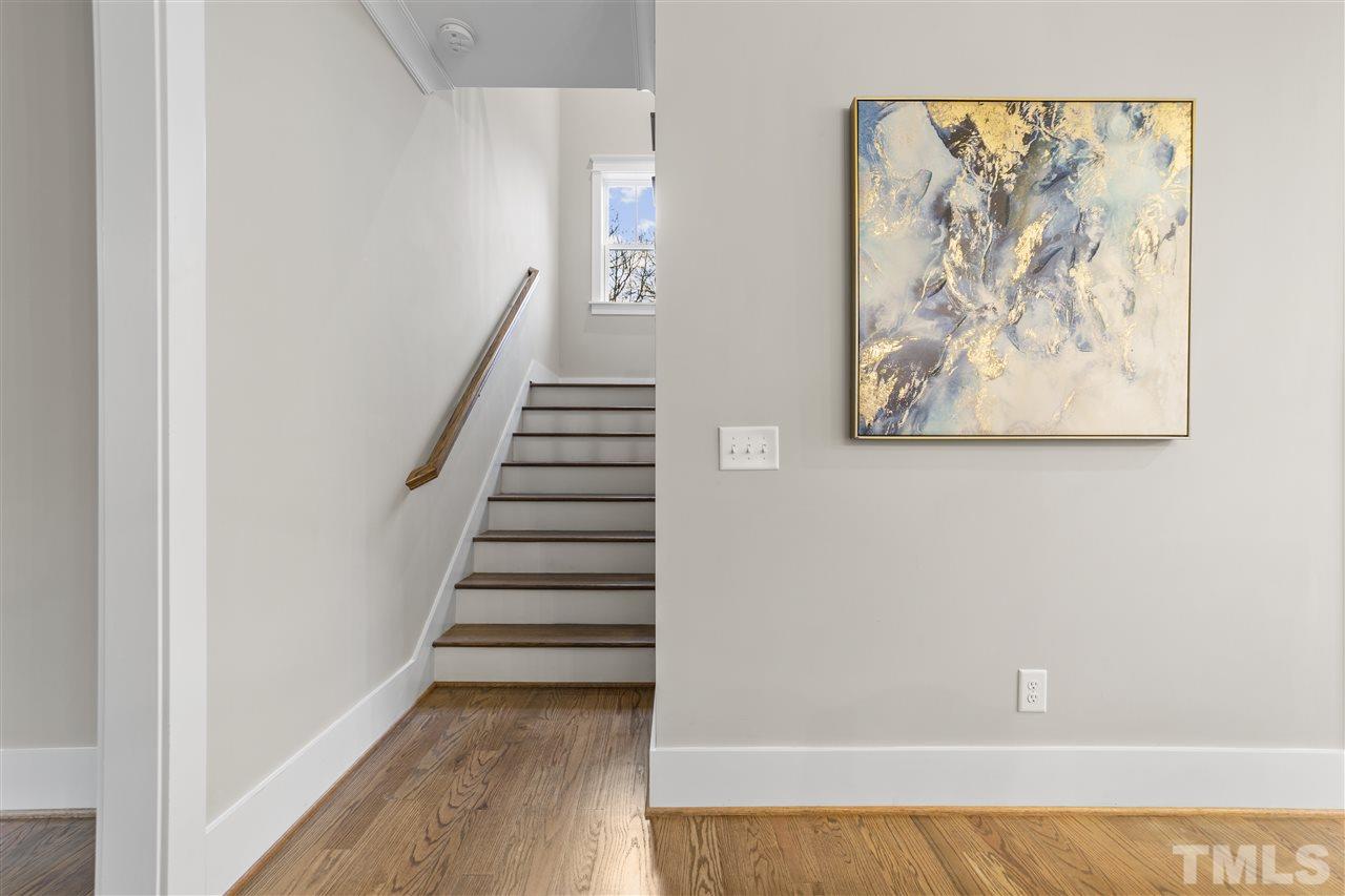 507 Hamilton Cottage Way Raleigh, NC 27605 - Photo 14 of 30 a view of a hallway with paintings on the wall