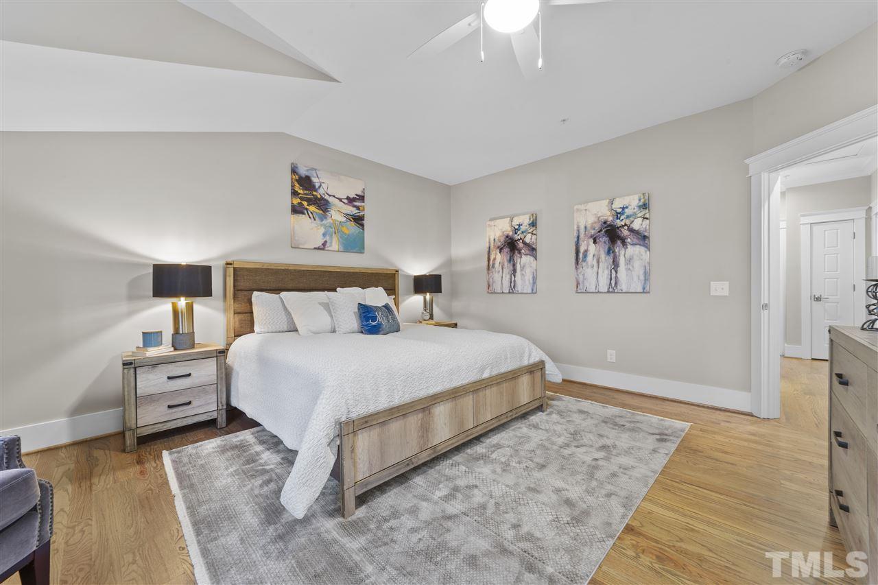 507 Hamilton Cottage Way Raleigh, NC 27605 - Photo 16 of 30 a bedroom with a bed and a chandelier