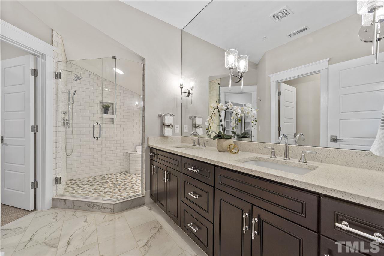 507 Hamilton Cottage Way Raleigh, NC 27605 - Photo 17 of 30 a bathroom with a sink double vanity granite tub shower and a mirror