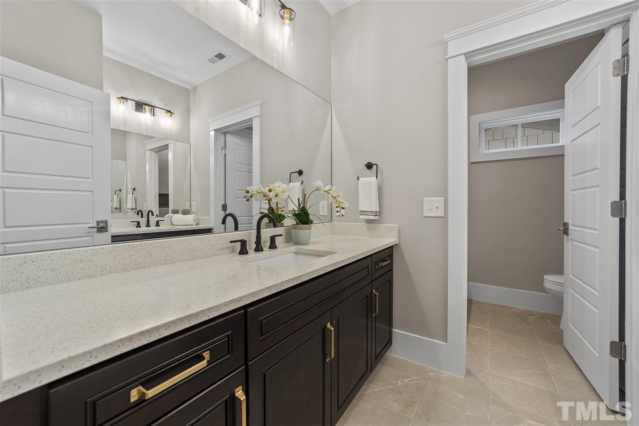 507 Hamilton Cottage Way Raleigh, NC 27605 - Photo 20 of 30 a bathroom with a sink and a mirror