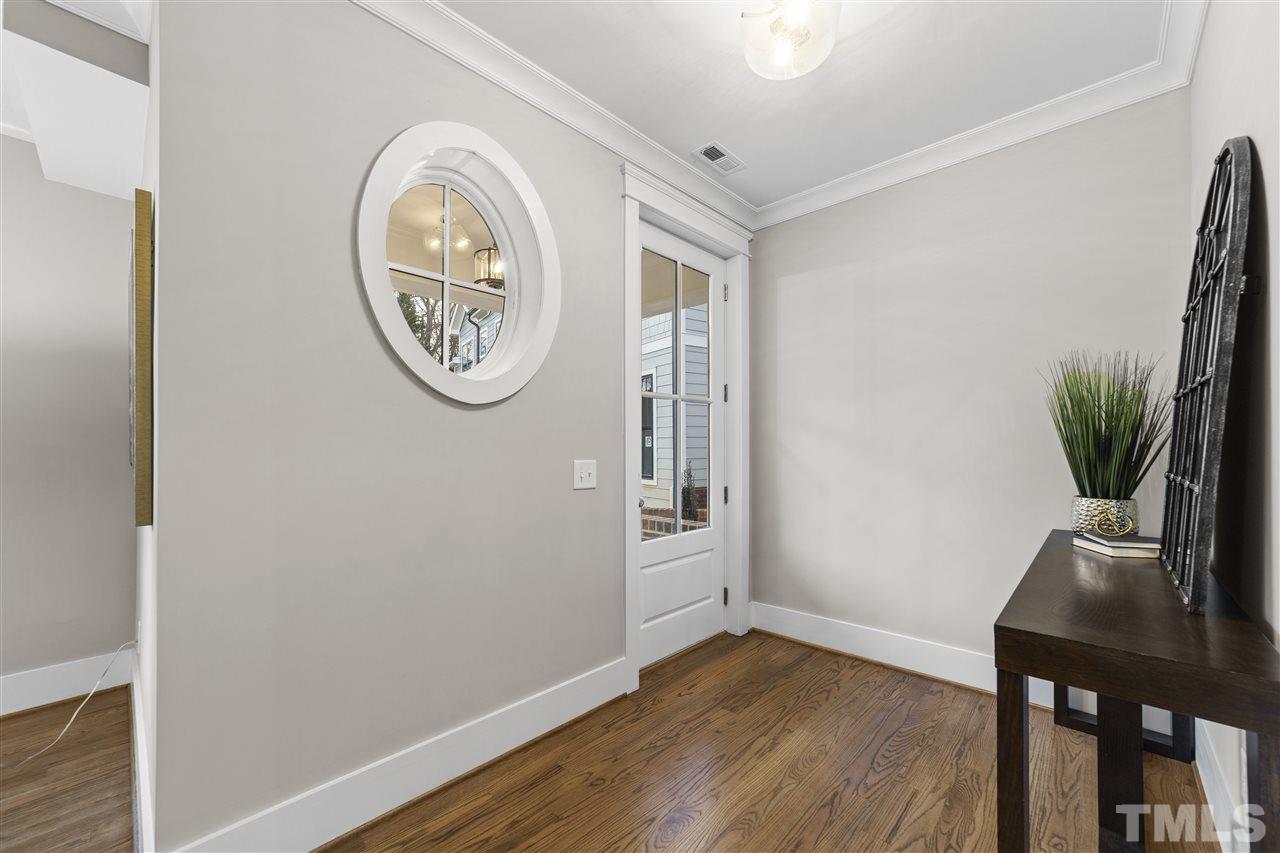 507 Hamilton Cottage Way Raleigh, NC 27605 - Photo 4 of 30 a view of a room with wooden floor and a potted plant