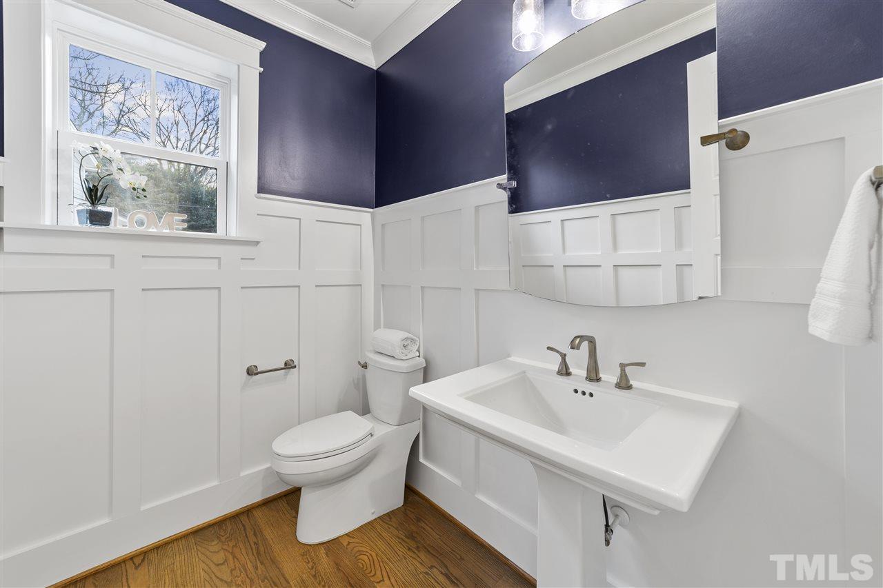 507 Hamilton Cottage Way Raleigh, NC 27605 - Photo 7 of 30 a white toilet sitting next to a bathroom sink