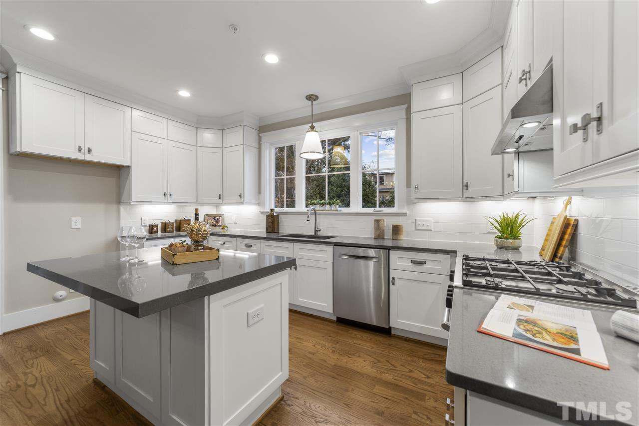 507 Hamilton Cottage Way Raleigh, NC 27605 - Photo 10 of 30 a kitchen with stainless steel appliances granite countertop a sink stove and cabinets