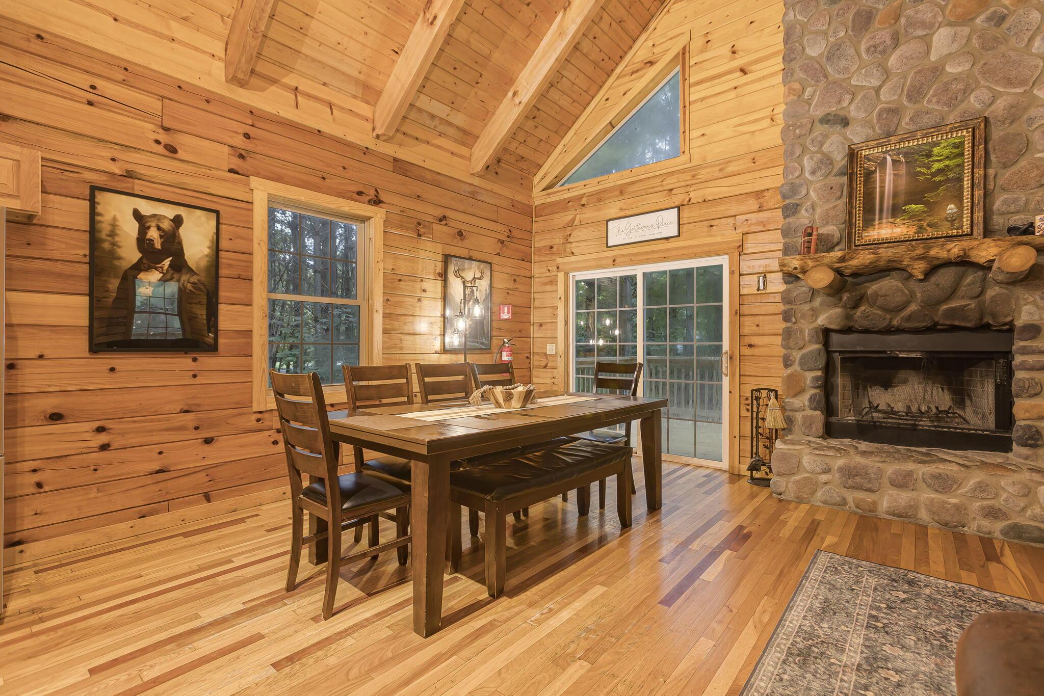 19475 Linden Road Logan, OH 43138 - Photo 15 of 94 Spacious living area featuring a stone-clad fireplace with a log mantel, wood-finish flooring, and natural wood paneling throughout