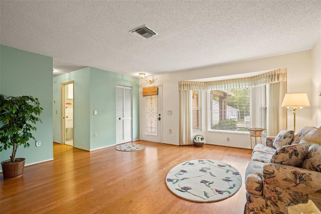 a view of a livingroom with wooden floor and a potted plant