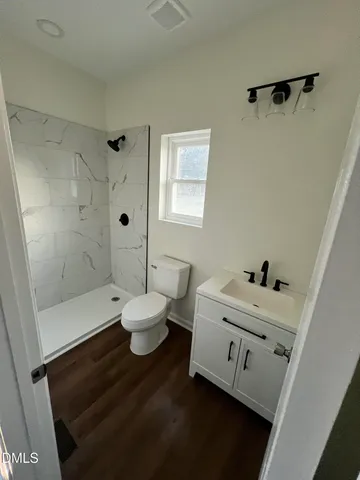 a bathroom with a bathtub sink mirror and toilet