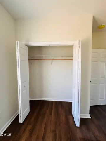 an empty room with wooden floor